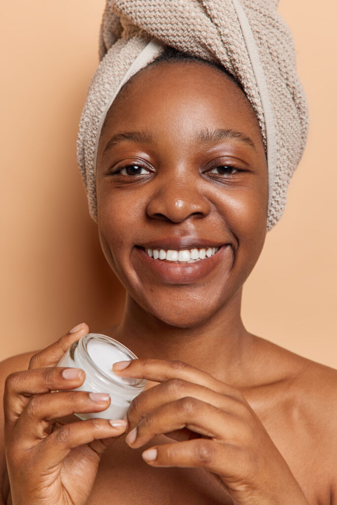 woman applying moisturizer . Skincare practices for your 20's