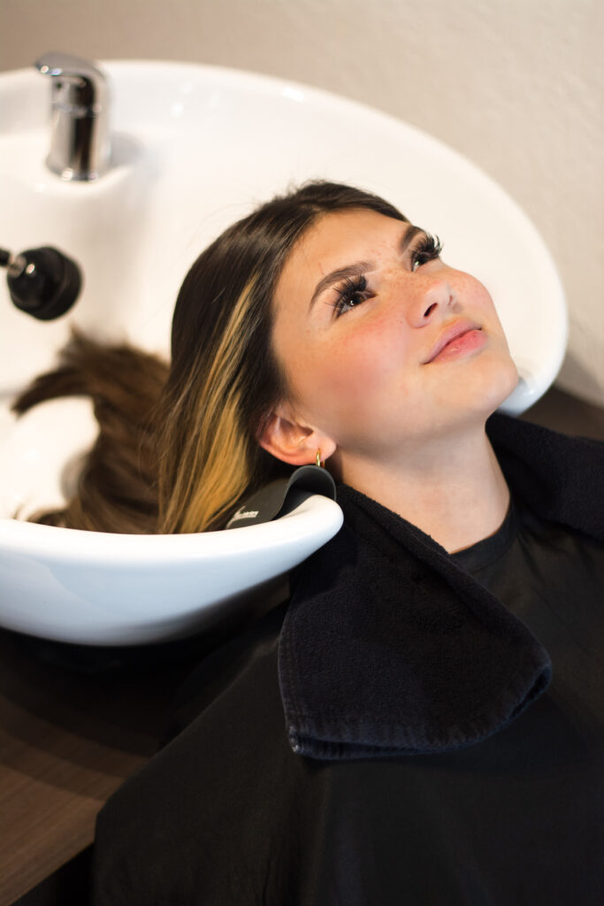 Young woman enjoying a shampoo service at changes salon and day spa